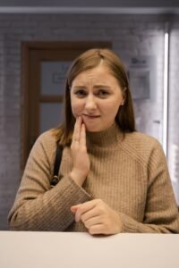 Patient with tooth pain visiting an emergency dentist in Woodbridge