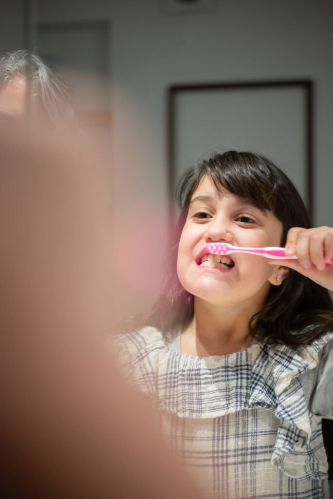 Young girl practising tongue and brushing habits at home
