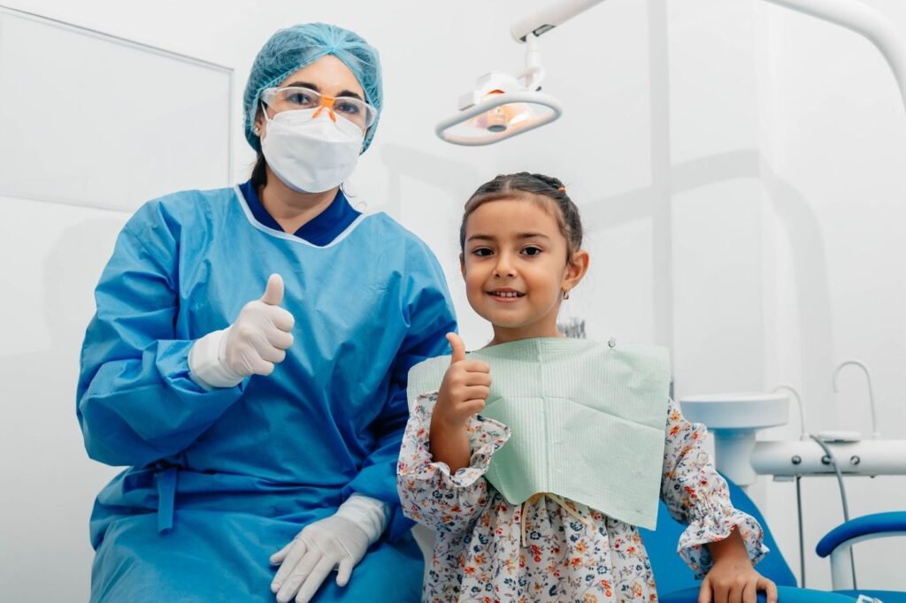 Child giving a thumbs up after a visit to a kids dentist in Woodbridge