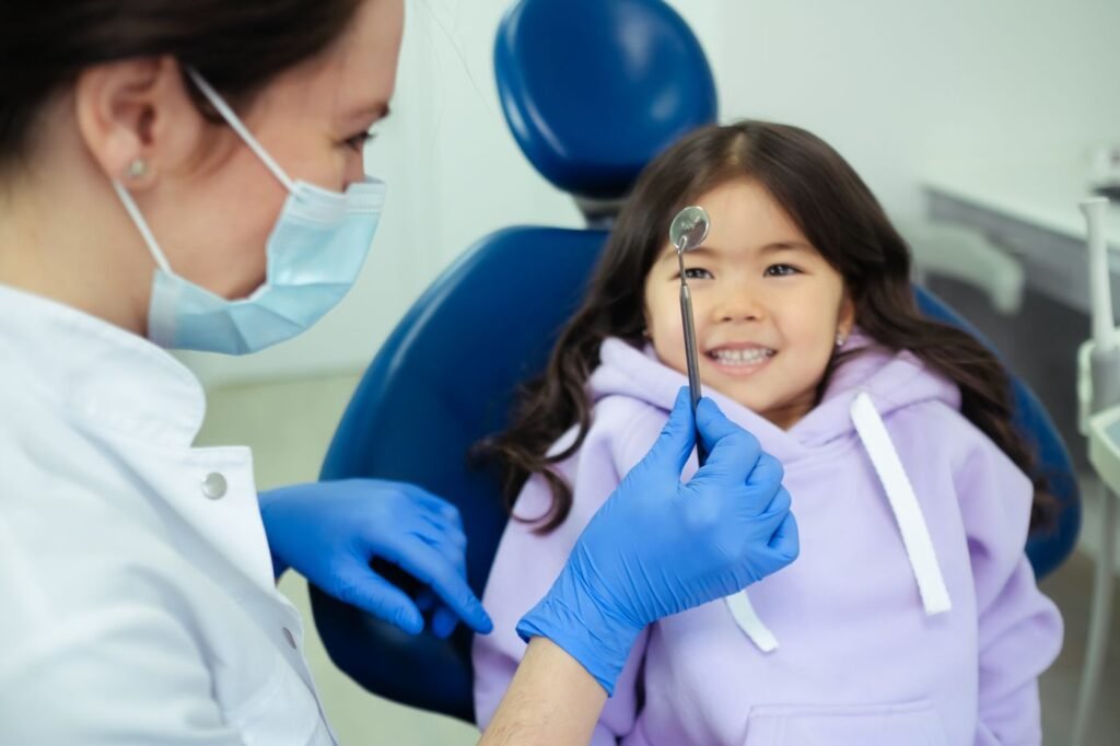 Pediatric dentist in Woodbridge with a smiling child during a checkup