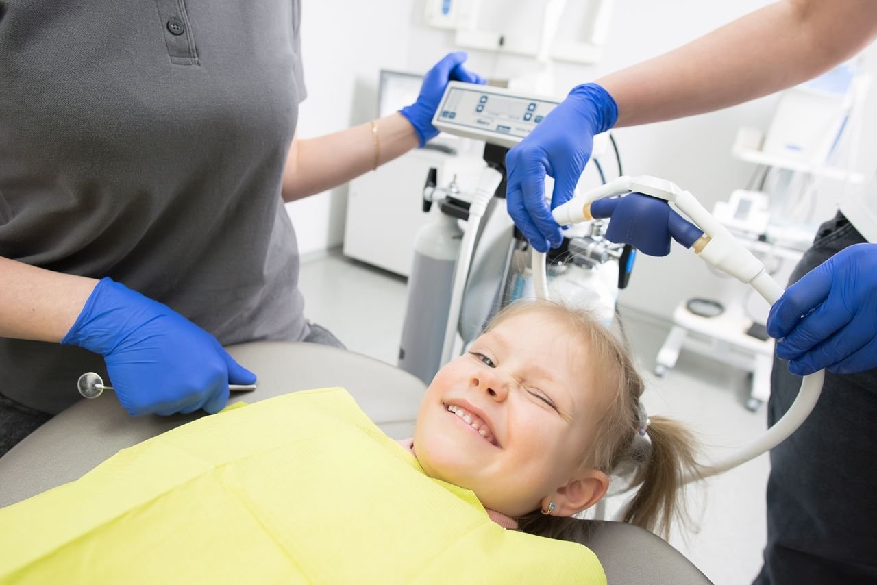 Smiling girl relaxing in a dental chair